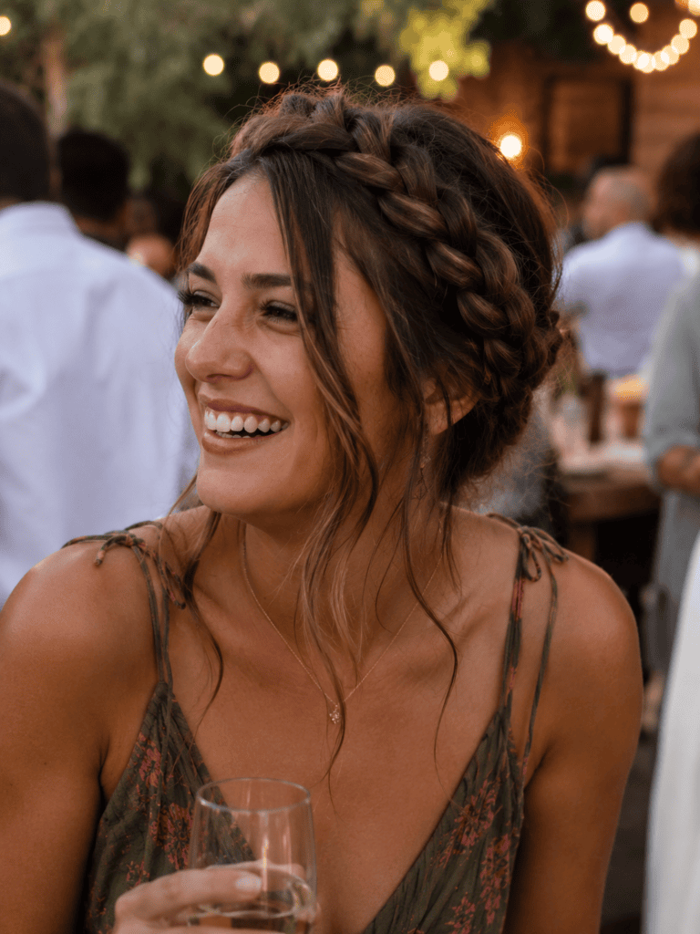 Elegant crown braid long hairstyle at an outdoor evening wedding