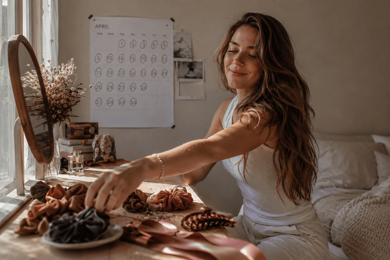 Woman with long wavy hair at her vanity preparing to try different long hairstyles